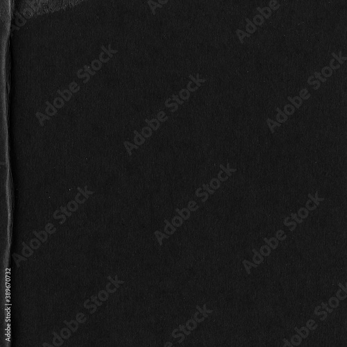 Black vintage rough sheet of carton. Recycled environmentally friendly cardboard paper texture. Simple gray minimalist papercraft background.