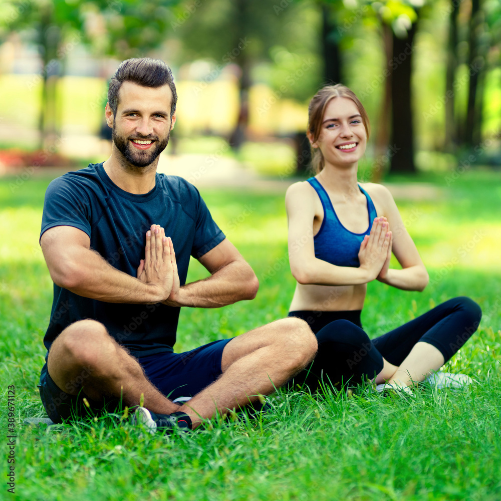 Young couple or woman training with male bearded instructor, doing yoga exercises or meditating together, outdoor concept. Square composition picture. Young couple or woman training with male bearded instructor, doing yoga exercises or meditating together, outdoor concept. Square composition picture.