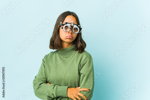 Young oculist latin woman over isolated background © Asier