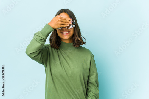 Young oculist latin woman over isolated background © Asier