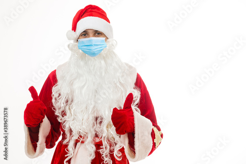 Illness and colds. santa claus in medical mask. red background.