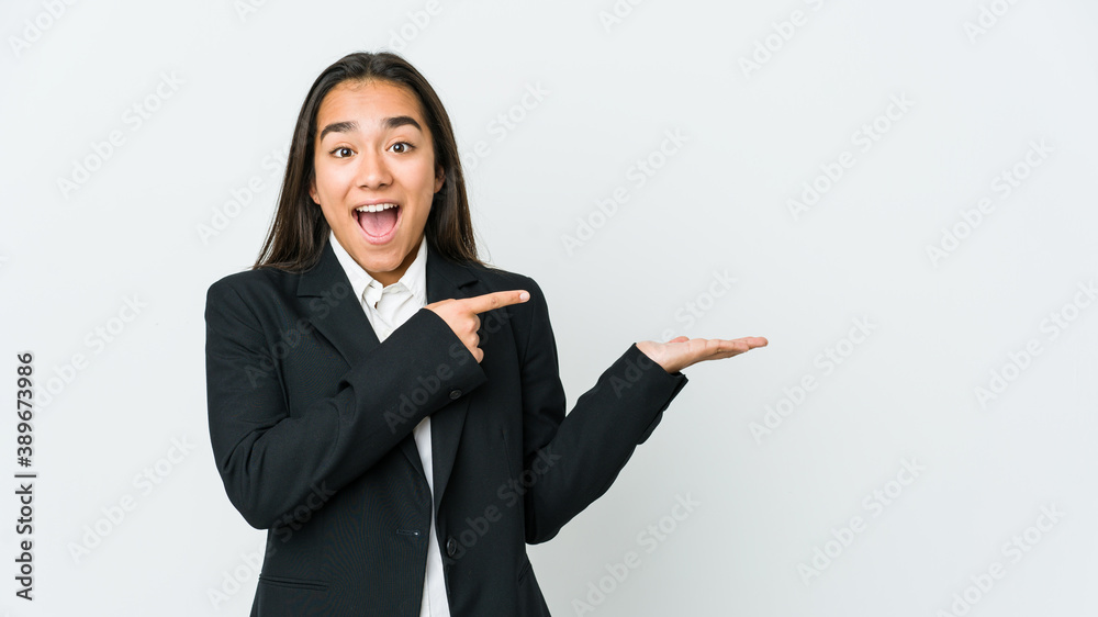 Young asian bussines woman isolated on white background excited holding a copy space on palm. Young asian bussines woman isolated on white background excited holding a copy space on palm.