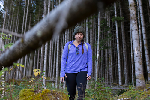 A woman walking out of the dense woods photo