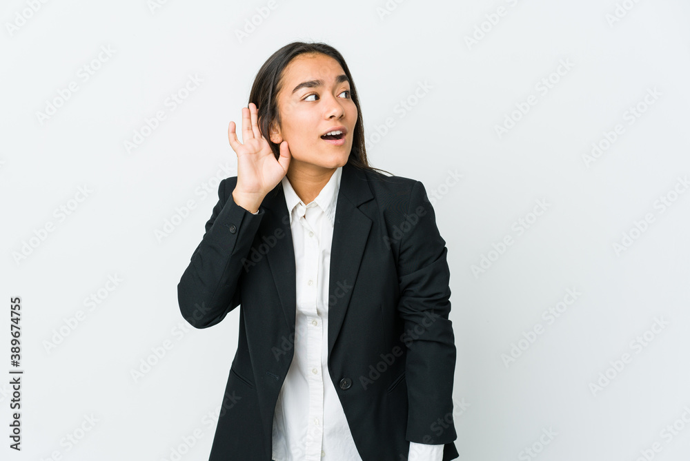 Young asian bussines woman isolated on white background trying to listening a gossip. Young asian bussines woman isolated on white background trying to listening a gossip.