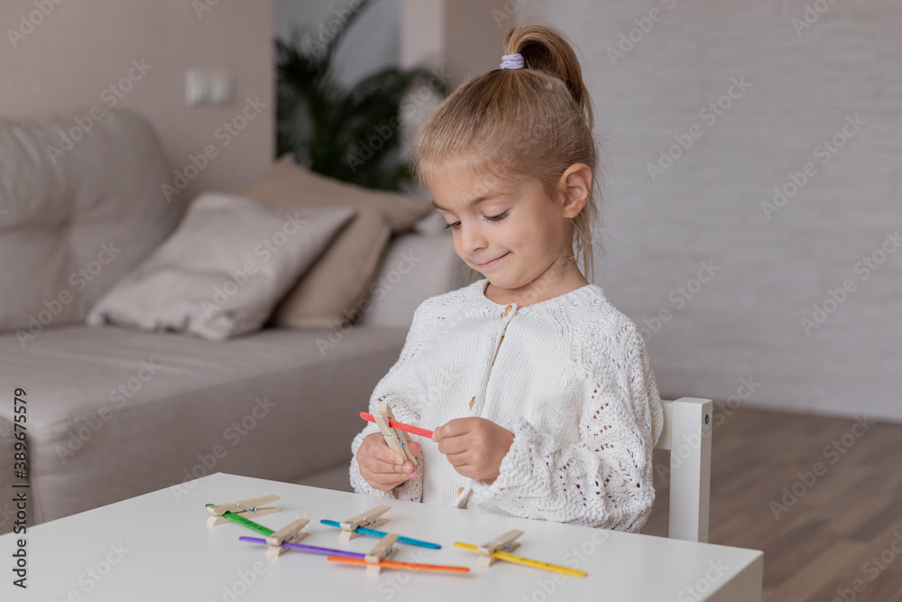 child solves examples in math with didactic materials, home education, activity for toddler. child solves examples in math with didactic materials, home education, activity for toddler.