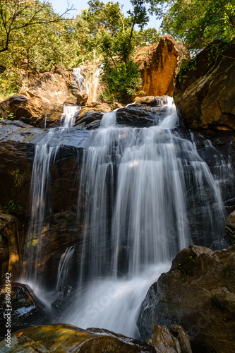 Bamni Waterfall is a A much spread-out waterfall and cascades over the rock face in three different stages.  Slow Shutter speed is used.