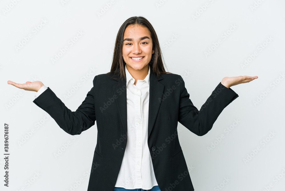 Young asian bussines woman isolated on white background makes scale with arms, feels happy and confident. Young asian bussines woman isolated on white background makes scale with arms, feels happy and confident.