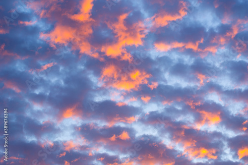 Beautiful clouds at sunset of orange and shades of blue