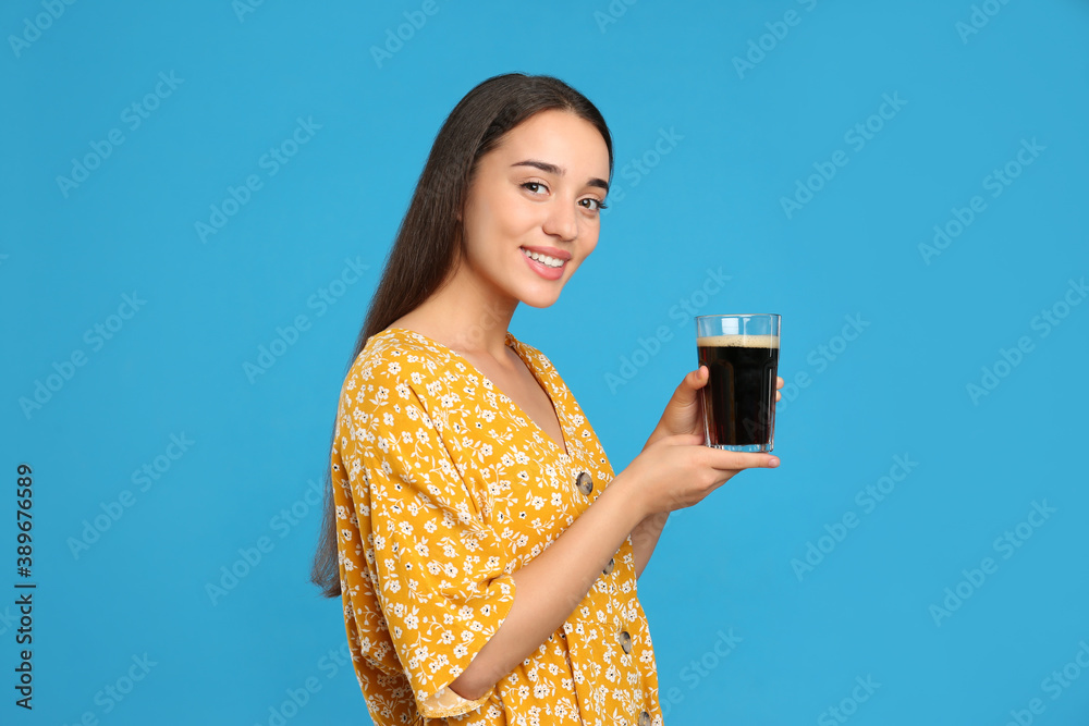 Beautiful woman with cold kvass on blue background. Traditional Russian summer drink Beautiful woman with cold kvass on blue background. Traditional Russian summer drink