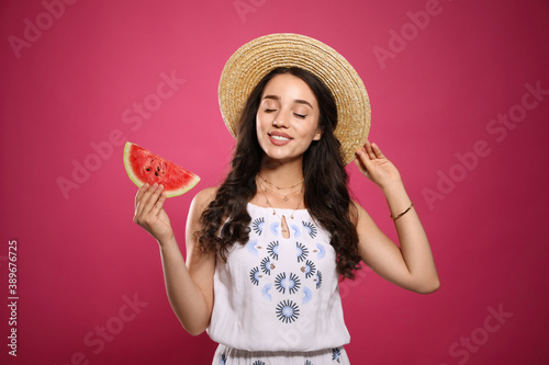 Beautiful young woman with watermelon on pink background