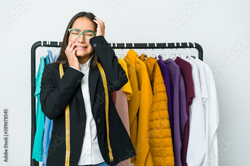 Young asian designer woman isolated on white background whining and crying disconsolately.