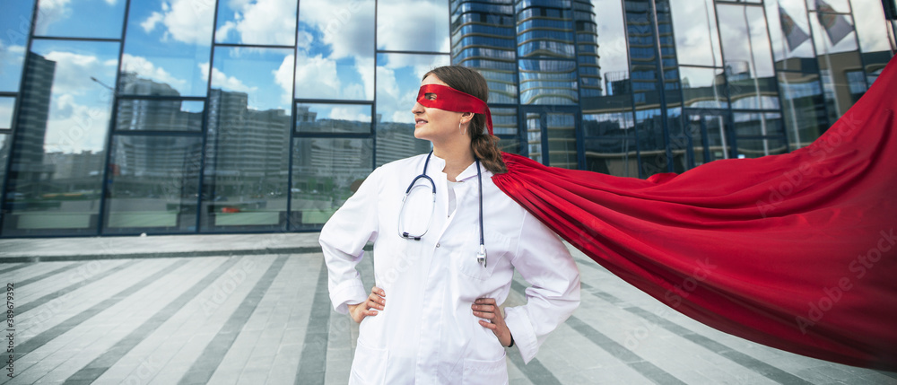 female doctor in a superhero raincoat looks at a city street .