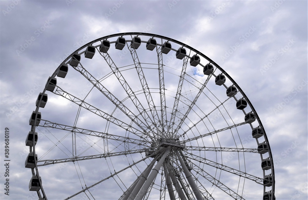 Ferris Wheel under a Cloud Sky at an Amusement Park