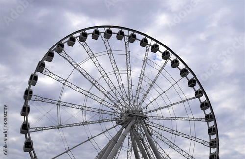 Ferris Wheel under a Cloud Sky at an Amusement Park