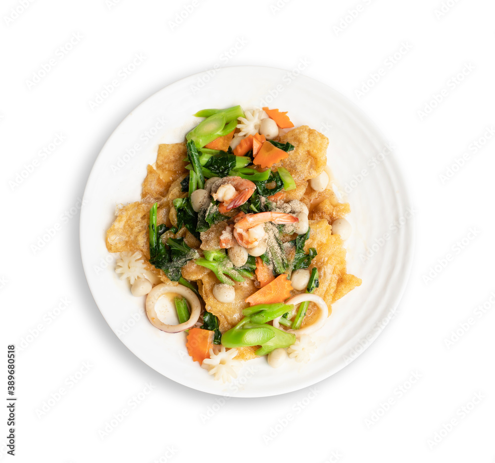 Fried noodle with seafood and vegetable in round white dish isolated on white background. Thai Food concept Fried noodle with seafood and vegetable in round white dish isolated on white background. Thai Food concept