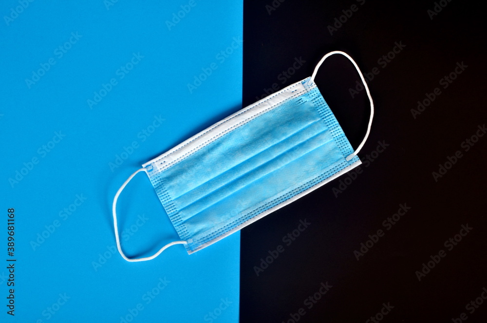 Medical face masks on a blue and black background. Coronavirus covid - 19 Concept Medical face masks on a blue and black background. Coronavirus covid - 19 Concept