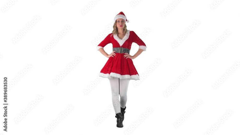 Confident young woman in Santa Claus costume walking with hands on hips. Full length isolated on white screen background. Confident young woman in Santa Claus costume walking with hands on hips. Full length isolated on white screen background.