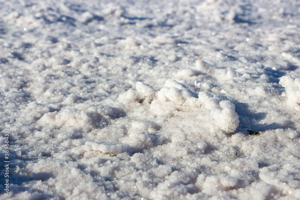 Background with the texture of salt formed on the shores of the lake due to evaporation of water.