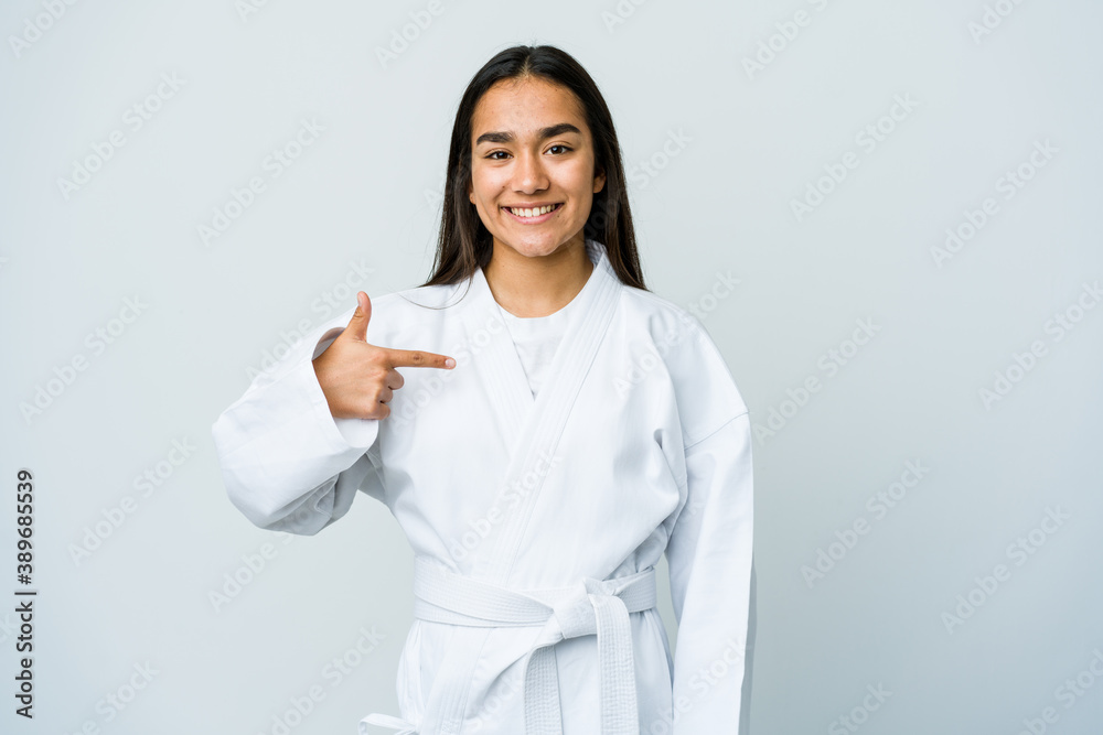 Young asian woman doing karate isolated on white background person pointing by hand to a shirt copy space, proud and confident Young asian woman doing karate isolated on white background person pointing by hand to a shirt copy space, proud and confident