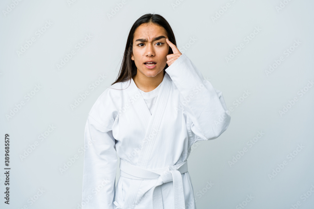 Young asian woman doing karate isolated on white background showing a disappointment gesture with forefinger. Young asian woman doing karate isolated on white background showing a disappointment gesture with forefinger.
