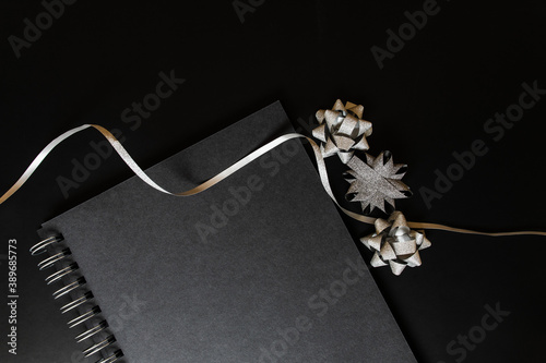 Black notebook mockup scene, with christmas silver items on black background