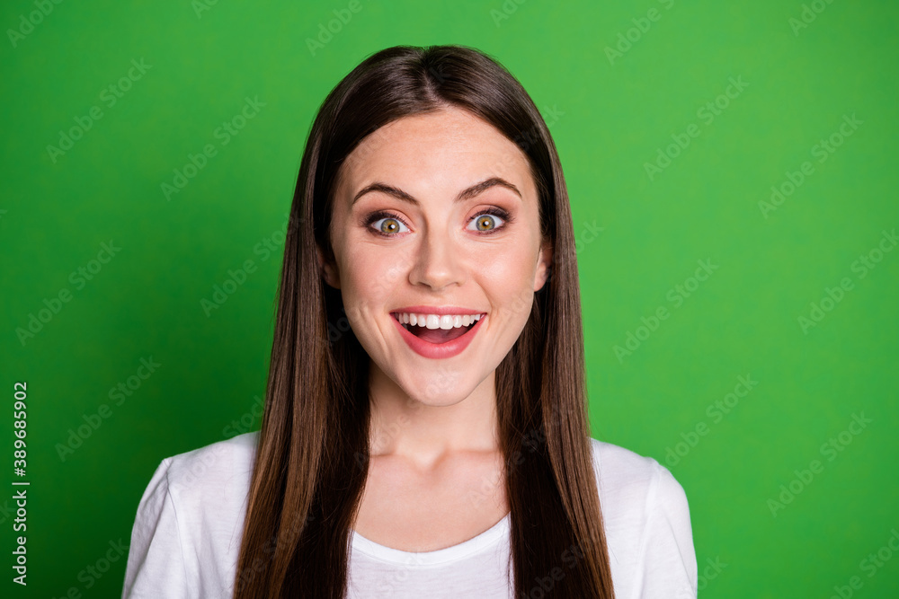 Fototapeta premium Photo portrait of happy excited girl isolated on vivid green colored background