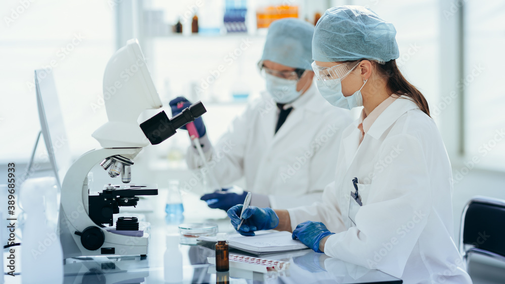 close up. scientists conduct research in a modern laboratory . close up. scientists conduct research in a modern laboratory .