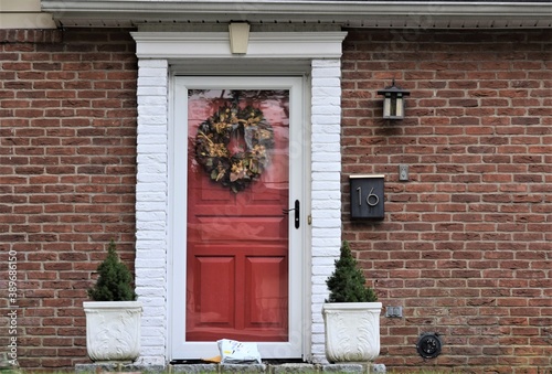A Package Lays Down on the Front Door of a Family House