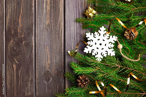 Fir tree branches with christmas decorations on wooden background