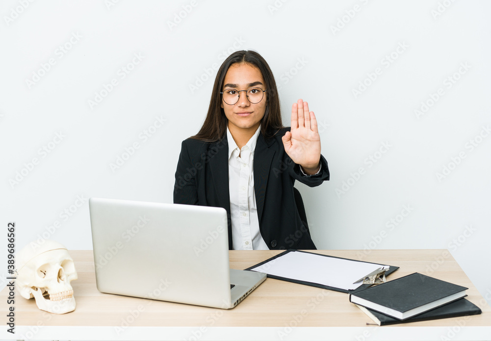 Young traumatologist asian woman isolated on white background standing with outstretched hand showing stop sign, preventing you. Young traumatologist asian woman isolated on white background standing with outstretched hand showing stop sign, preventing you.