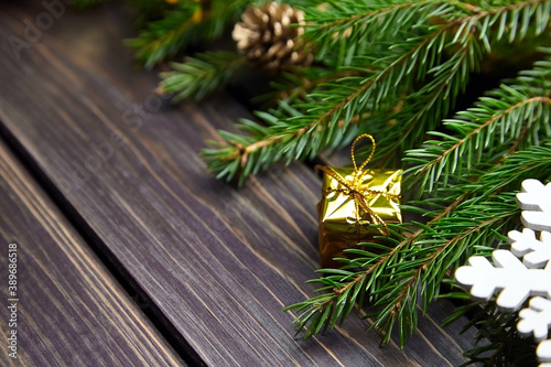 Fir tree branches with christmas decorations on wooden table