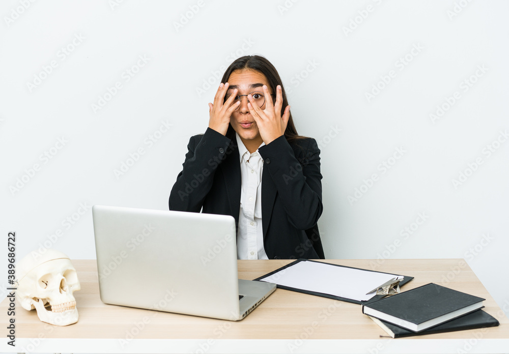 Young traumatologist asian woman isolated on white background blink through fingers frightened and nervous. Young traumatologist asian woman isolated on white background blink through fingers frightened and nervous.