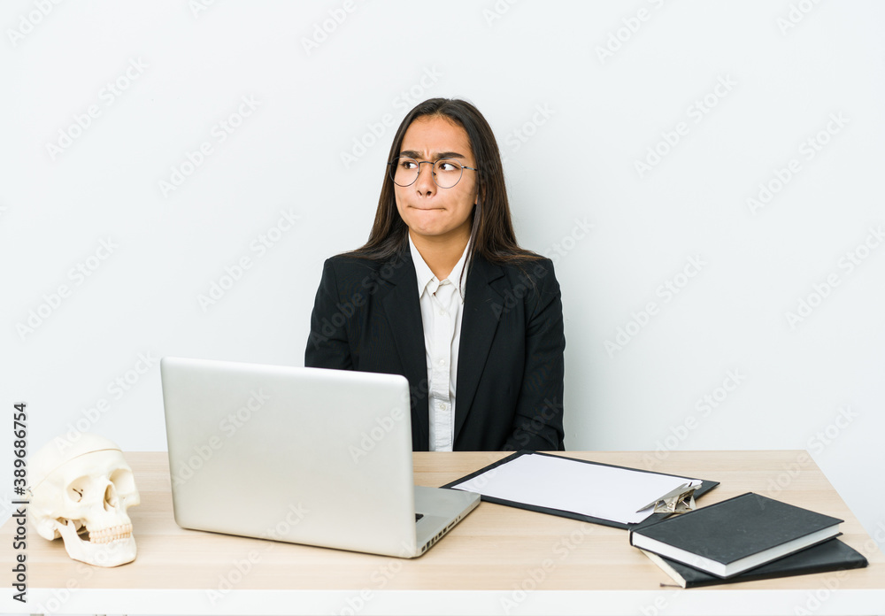 Young traumatologist asian woman isolated on white background confused, feels doubtful and unsure. Young traumatologist asian woman isolated on white background confused, feels doubtful and unsure.