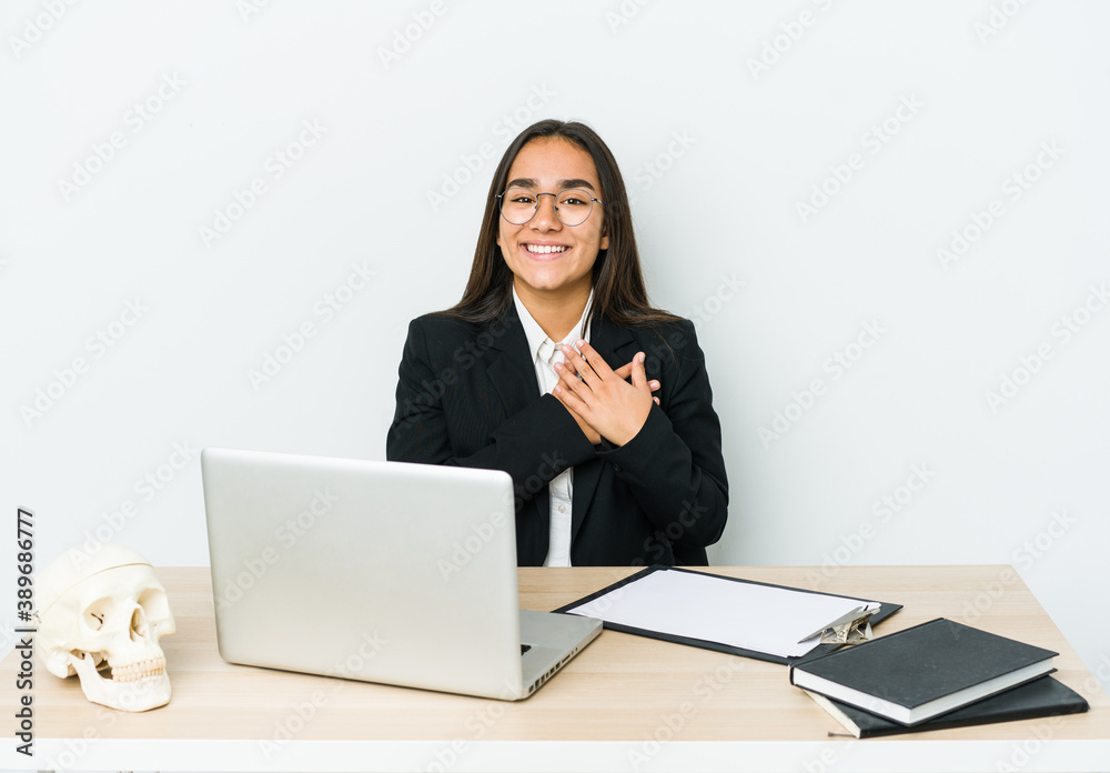 Young traumatologist asian woman isolated on white background has friendly expression, pressing palm to chest. Love concept. Young traumatologist asian woman isolated on white background has friendly expression, pressing palm to chest. Love concept.