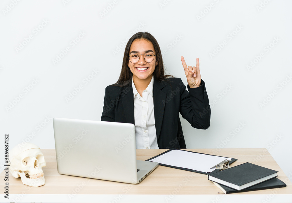 Young traumatologist asian woman isolated on white background showing a horns gesture as a revolution concept. Young traumatologist asian woman isolated on white background showing a horns gesture as a revolution concept.