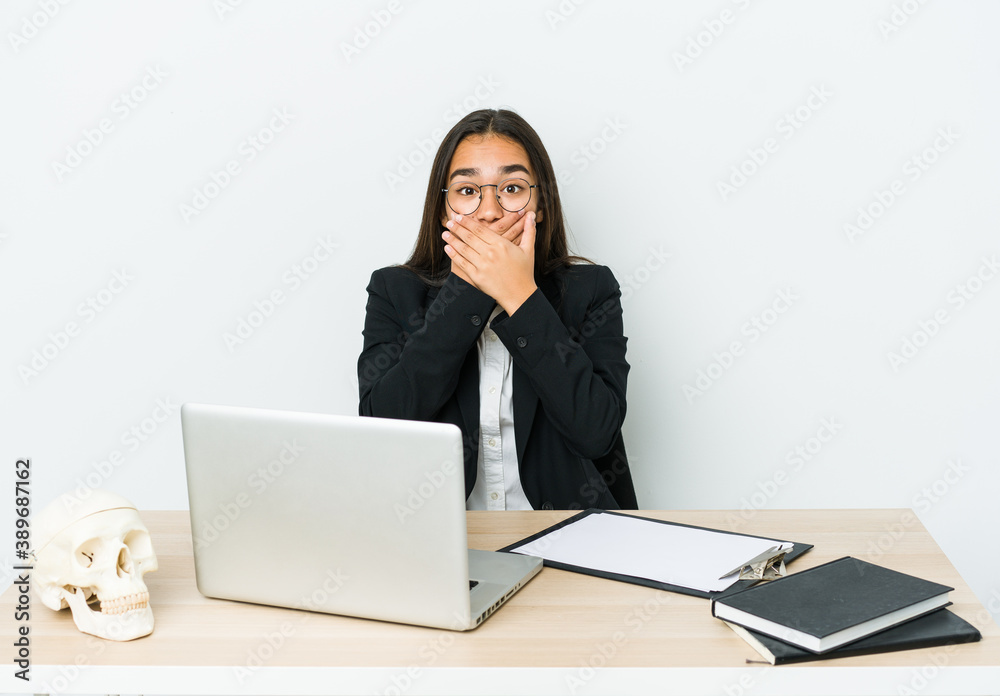 Young traumatologist asian woman isolated on white background shocked covering mouth with hands. Young traumatologist asian woman isolated on white background shocked covering mouth with hands.