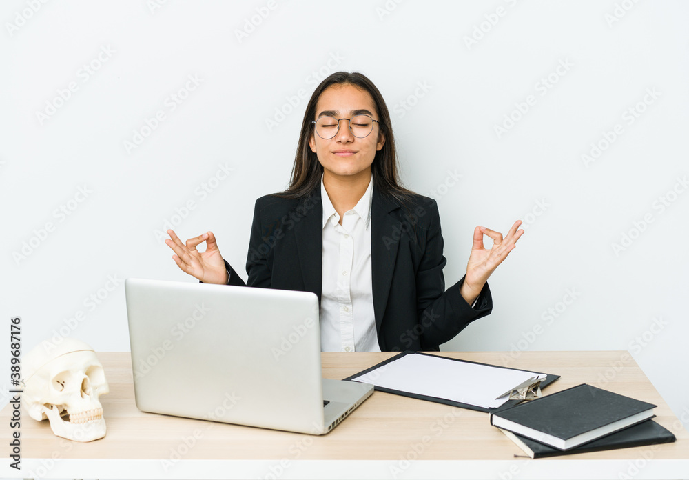 Young traumatologist asian woman isolated on white background relaxes after hard working day, she is performing yoga. Young traumatologist asian woman isolated on white background relaxes after hard working day, she is performing yoga.