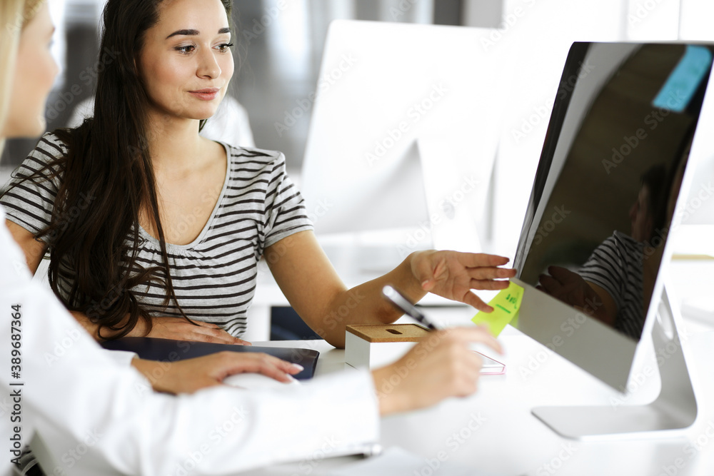 Group of business people discussing questions at meeting. Headshot of casual dressed businesswoman happy smiling to her colleague at office negotiation. Teamwork and cooperation in corporate Group of business people discussing questions at meeting. Headshot of casual dressed businesswoman happy smiling to her colleague at office negotiation. Teamwork and cooperation in corporate