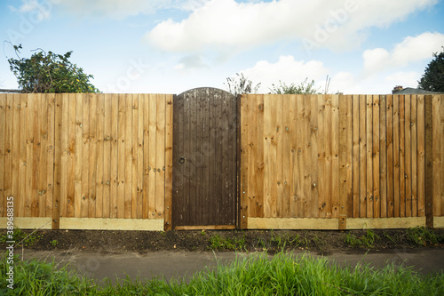 Gate in a wooden feather edge fence