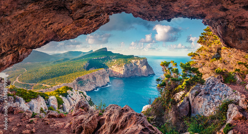 Astonishing summer view of Caccia cape from the small cave in the cliff. Fabulous morning scene of Sardinia island, Italy, Europe. Aerial Mediterranean seascape. Beauty of nature concept background. photo