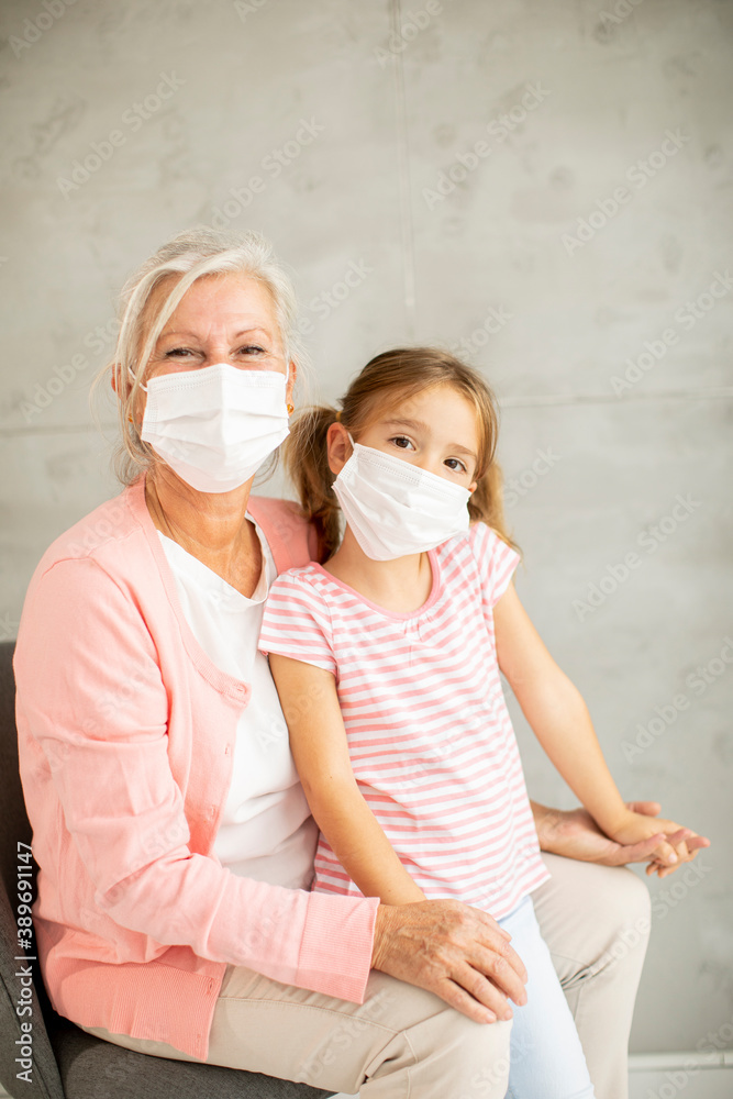 Grandmother and granddaughter wearing a respiratory masks