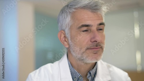 Wallpaper Mural Portrait of confident doctor with grey hair standing in hospital hallway Torontodigital.ca