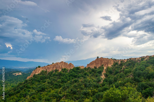 Sunset landscape of the Melnik Pyramids near the village of Rozhen, Southwest Bulgaria. Sand pyramids in the Pirin Mountains, view from Rozhen - Melnik hiking trail