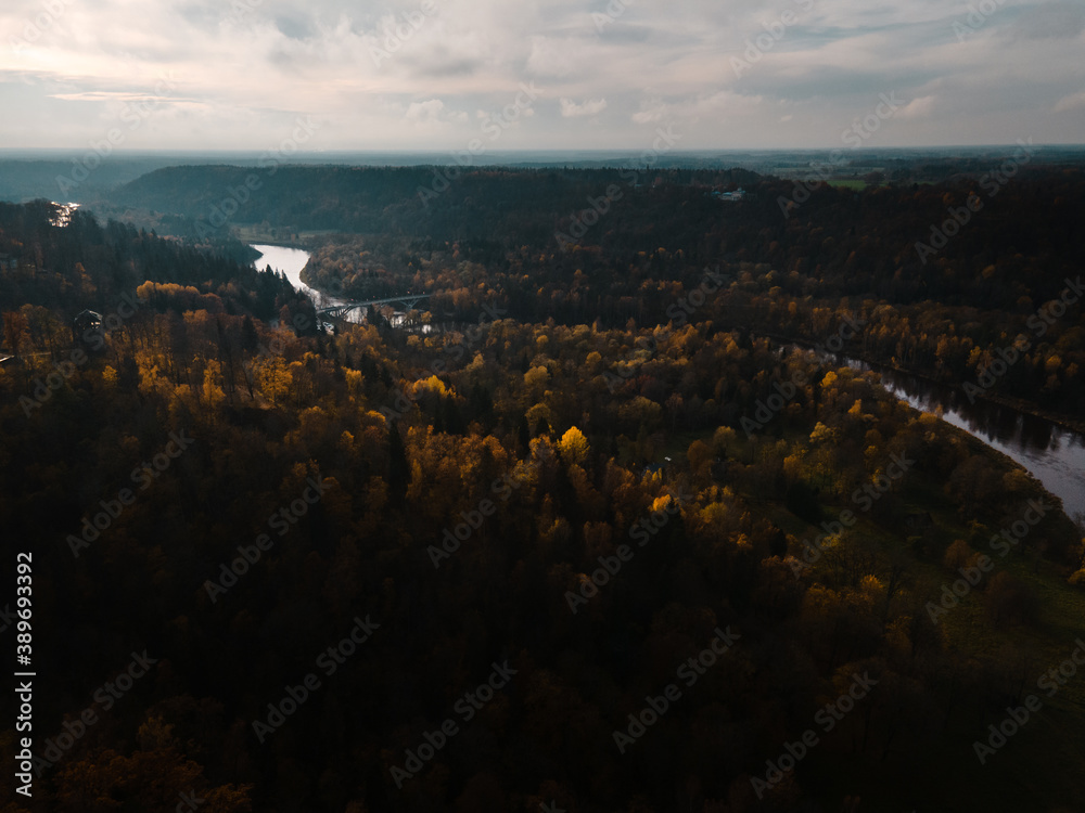 Establishing shot: Epic flight towards beautiful river valley Autumn landscape