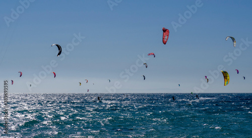 Set of people in the sea practicing kitesurfing in  Tarifa