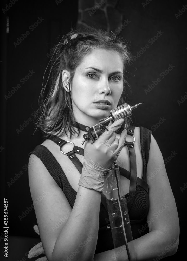 Tattoo artist posing in a tattoo studio Tattoo artist posing in a tattoo studio