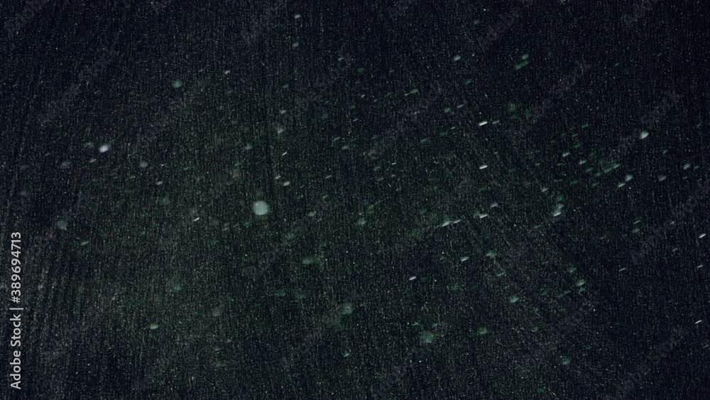 Real white dust floating in the air, in front of a dirty blackboard (used and cleaned many times over the years).
