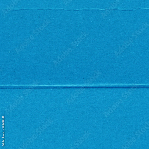 A blue vintage rough sheet of carton. Recycled environmentally friendly cardboard paper texture. Simple minimalist papercraft background.