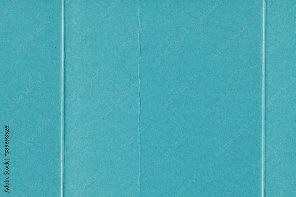Fototapeta premium A blue vintage rough sheet of carton. Recycled environmentally friendly cardboard paper texture. Simple minimalist papercraft background.