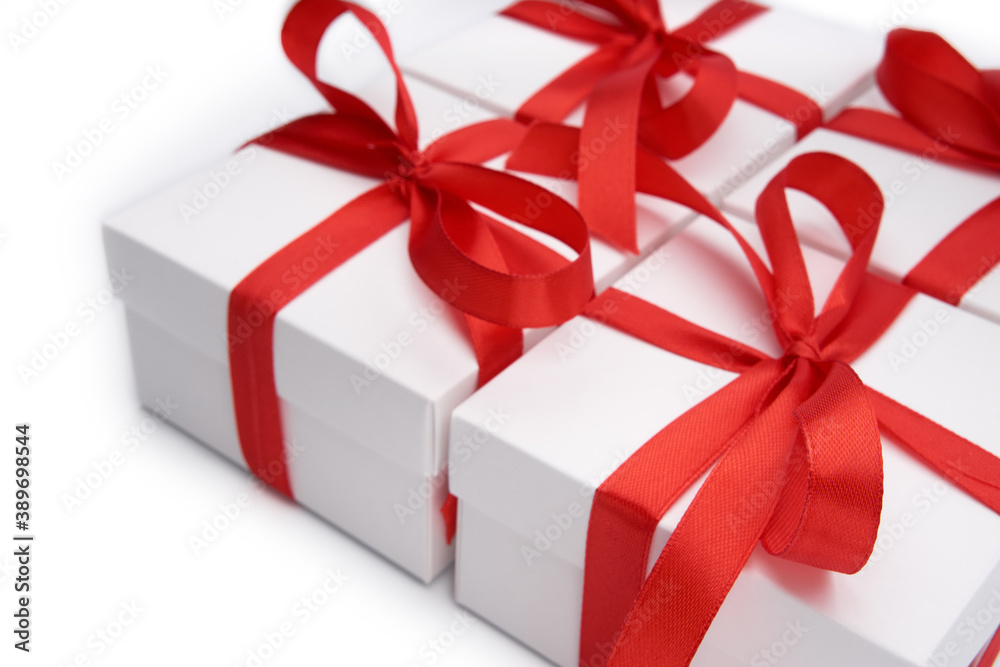 Obraz premium White gift box with red ribbon bow, isolated on white. White box with red ribbon. Gift for Christmas, New Year, Birthday, Valentine's Day. 